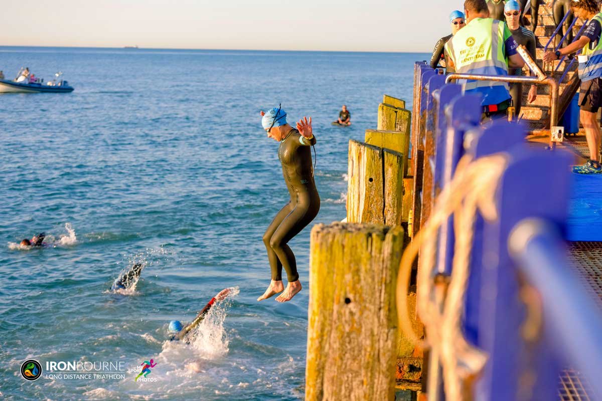 Rachel jumping off the Eastbourne Pier to start the Ironbourne Triathlon 2021